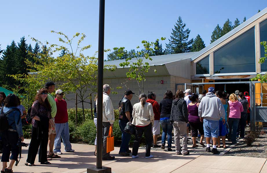 A line of visitors at the main entrance of the Hibulb Cultural Museum on a sunny day.